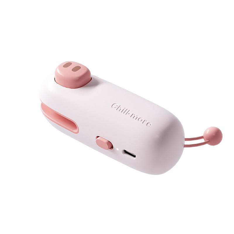 Close-up of Pink Pig bag sealer controls, charging port, and built-in cutter