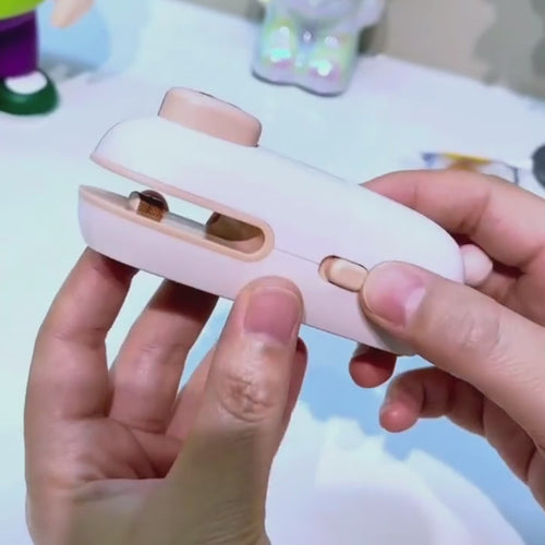 Rechargeable mini bag sealer demonstration showing cutting, heat sealing, USB-C charging, and magnetic storage